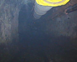 industrial pipe and hosing going down into a mine ventilation shaft