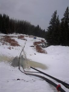 hard pipe configuration for material discharge in snow