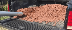 image of 1/2 ton truck filled with red lava rock